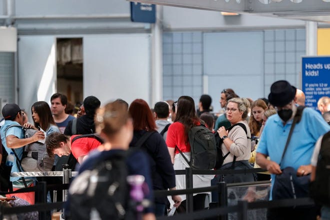 Travelers wait in line at O'Hare International Airport on June 30, 2022 in Chicago.